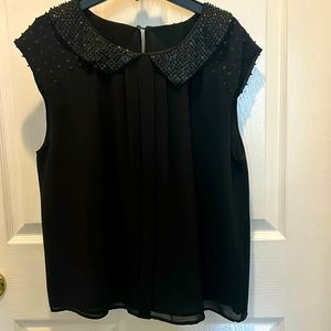 Women’s short cap sleeve black top with beaded collar and sleeves. Size M/L